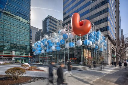 vibrant balloons nestle within metallic scaffolding atop seoul’s playful urban hub by SSP